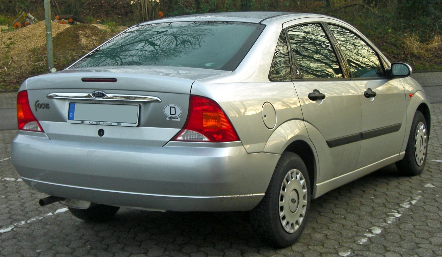 Rear sedan view with distinctive taillights and chrome trim