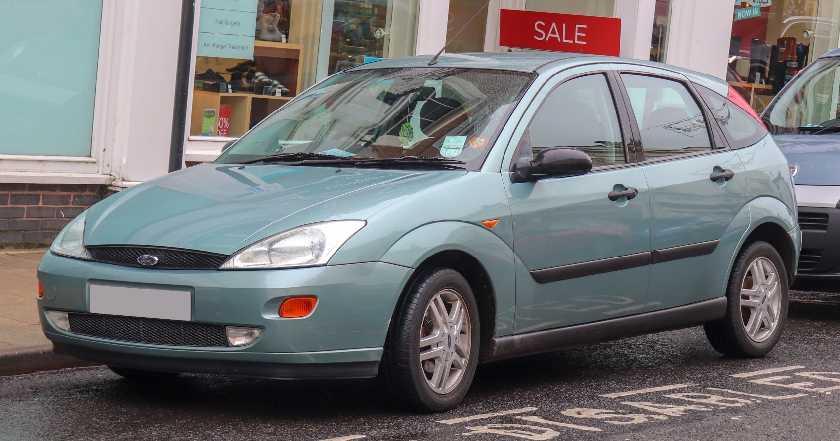 Front side view of a compact hatchback with rounded headlights and distinctive grille