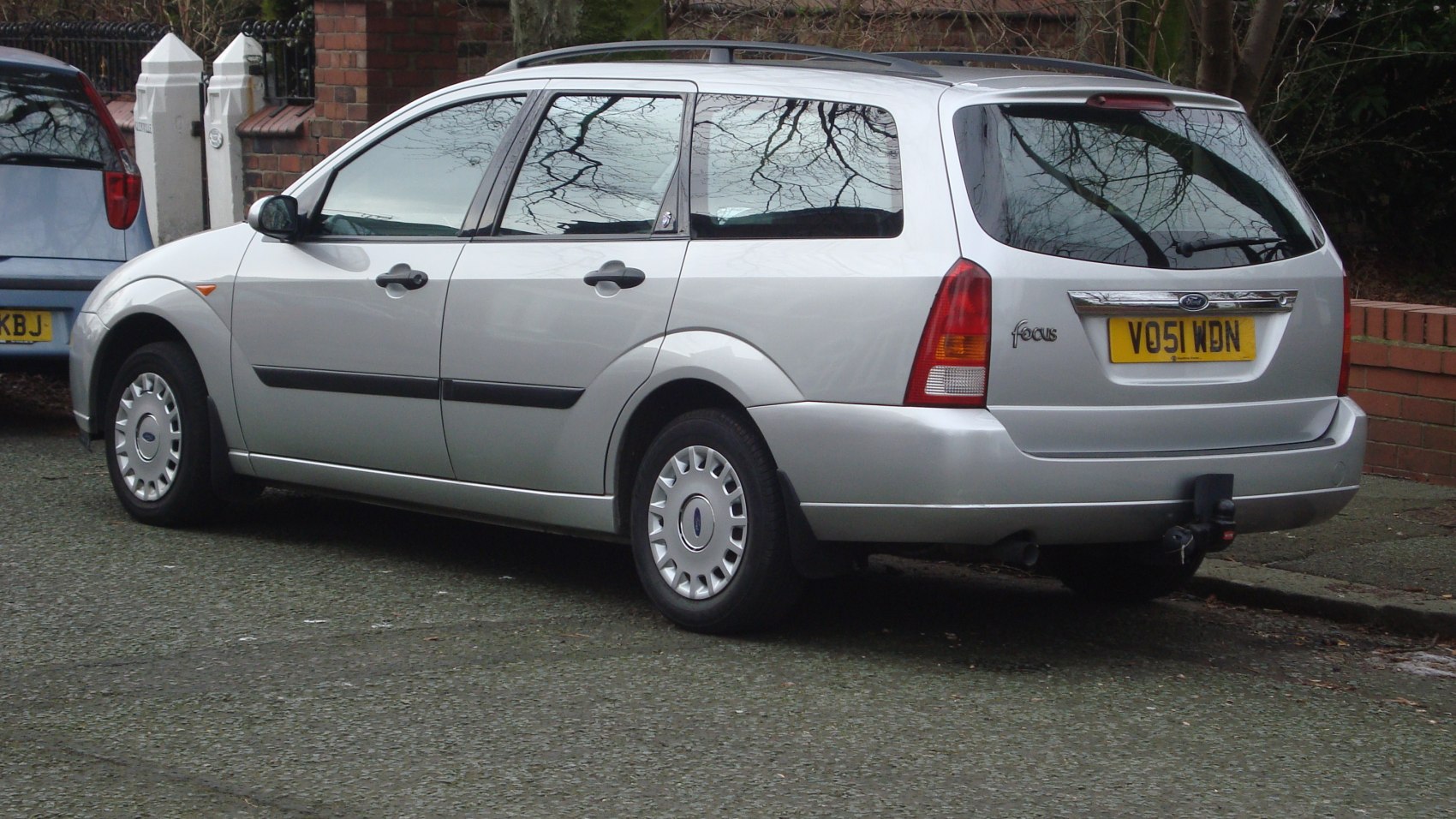 Silver station wagon rear and side view with roof rails and tow hitch