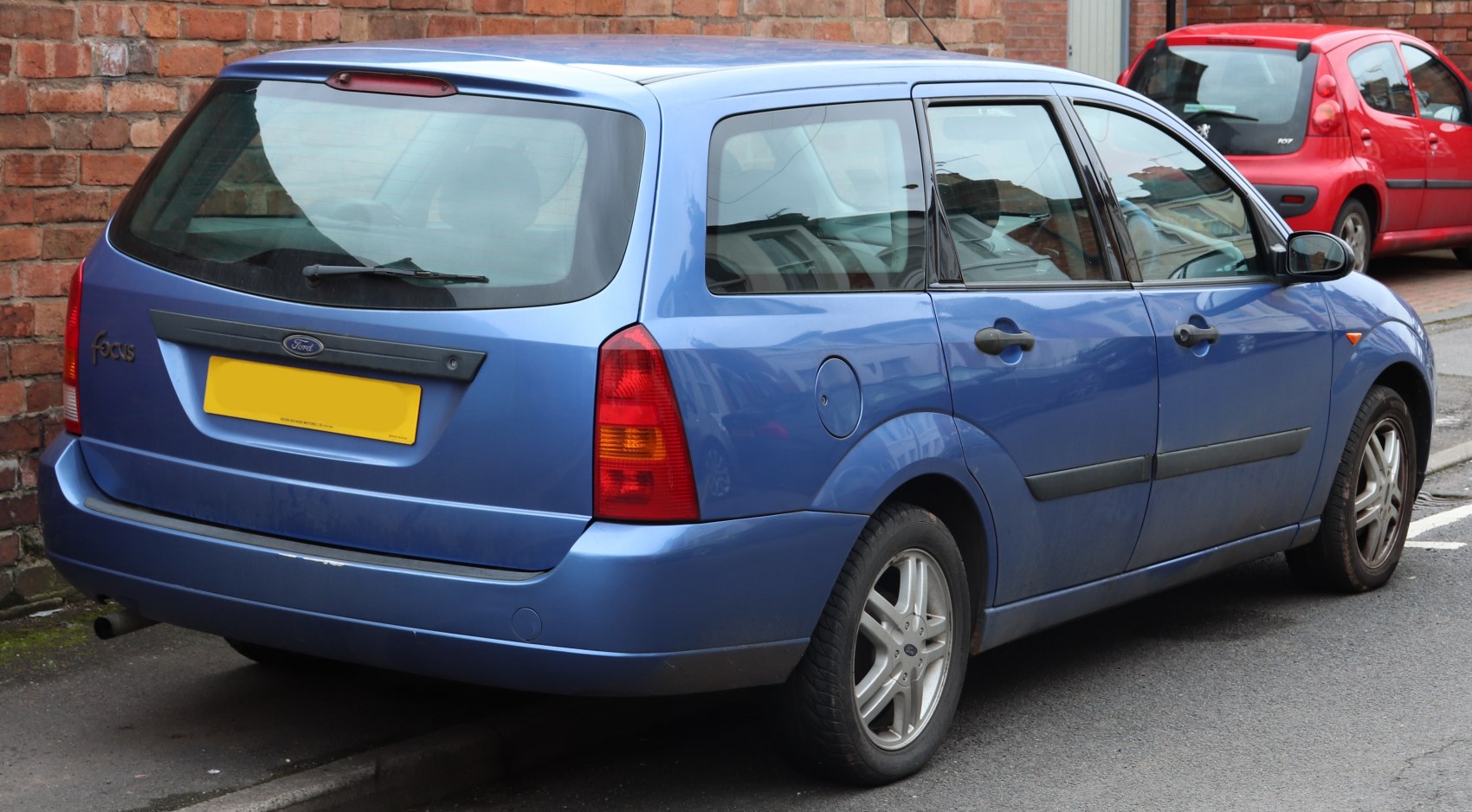Rear view of blue station wagon with tail lights and rear wiper