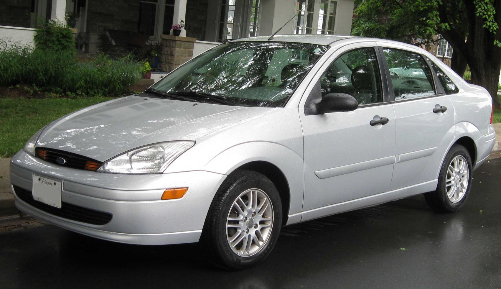 Compact sedan with distinctive headlights and alloy wheels