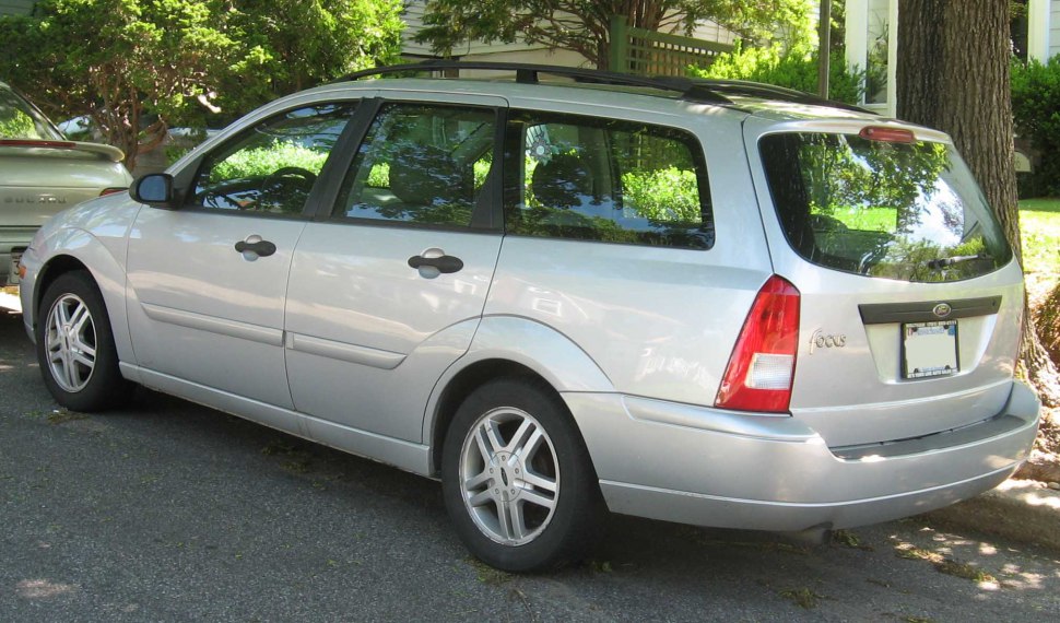 Silver station wagon rear side profile with alloy wheels and roof rails