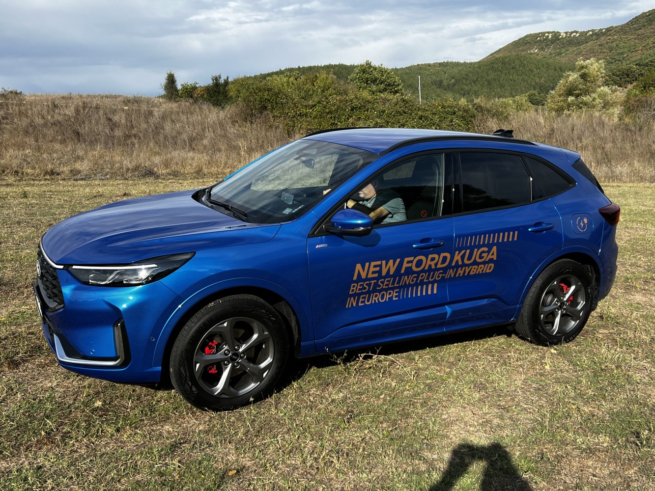 Side profile of sleek blue plug-in hybrid SUV with modern design details
