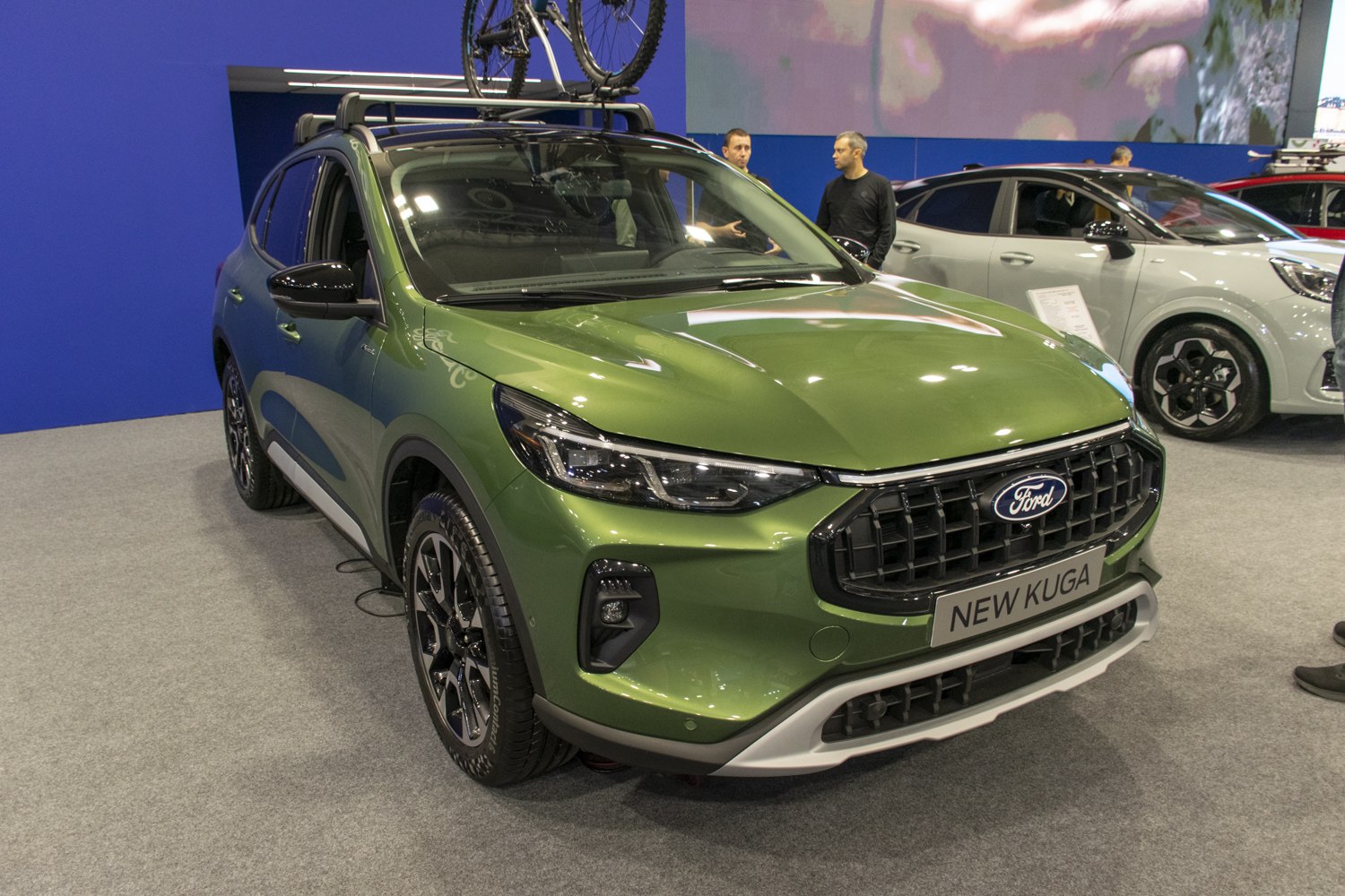 Front view of SUV with LED headlights and roof rack carrying a bicycle