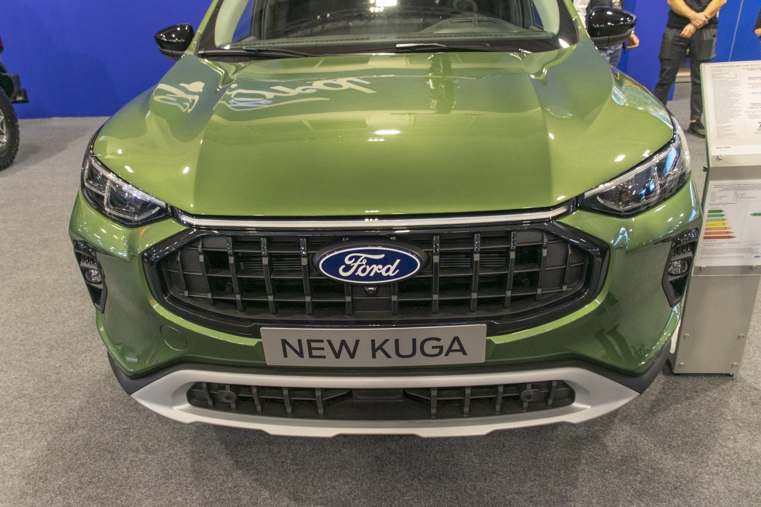 Front grill and headlights of modern SUV in green color