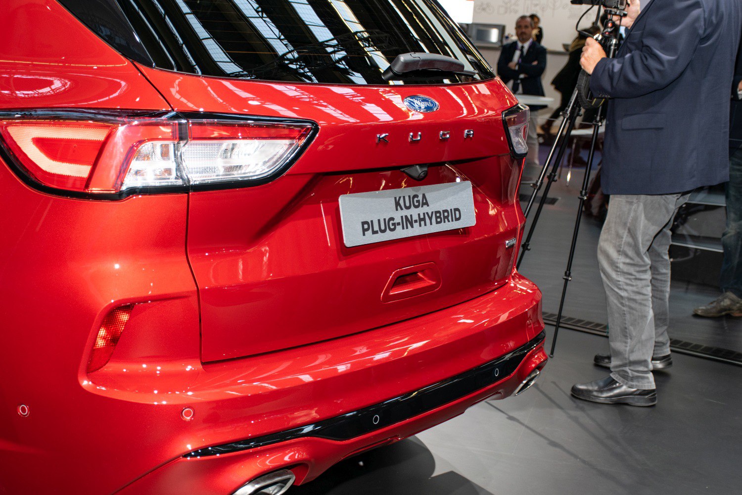 Rear view of red SUV with hybrid badge and distinctive taillights