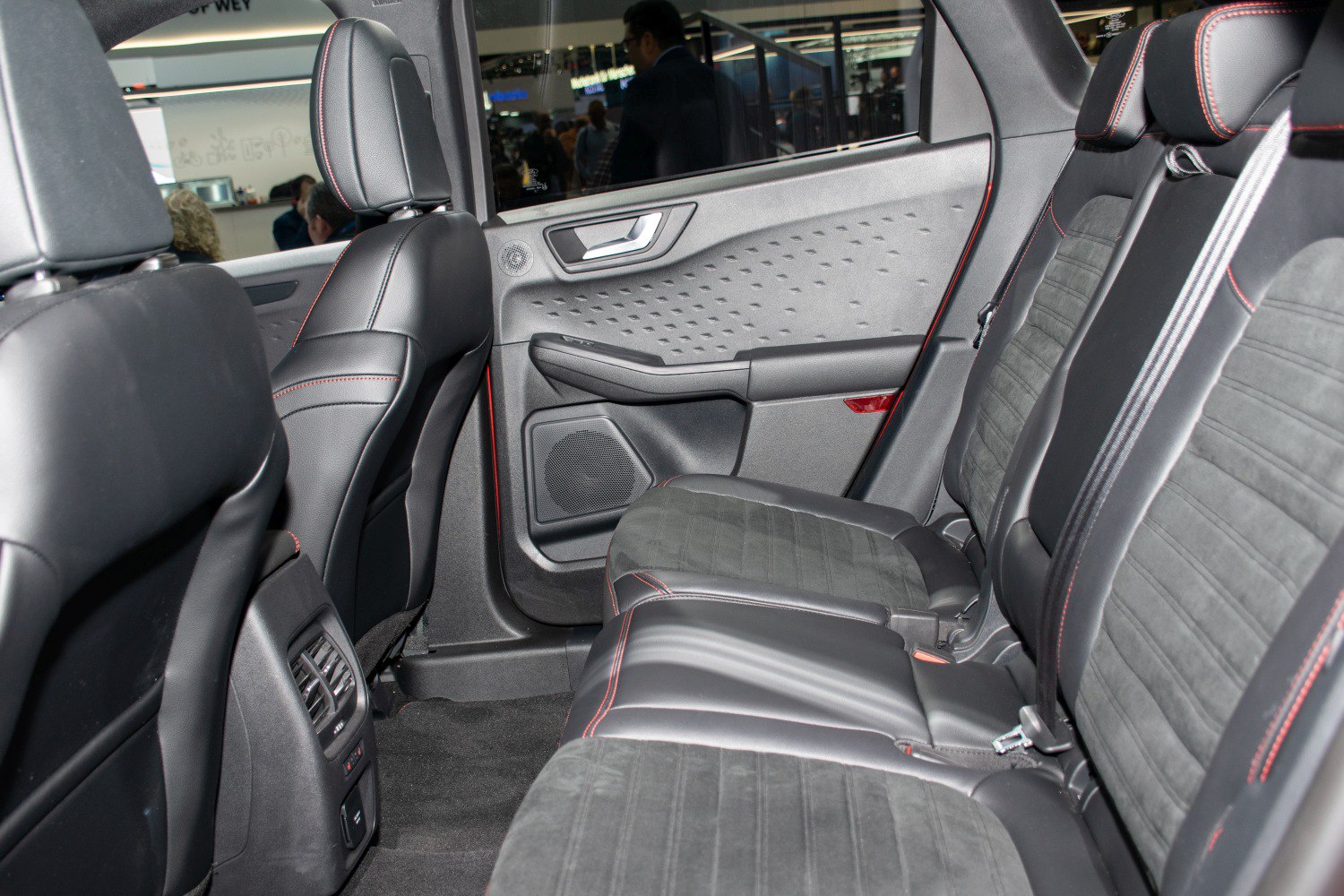 Rear seats and door panel with luxury upholstery and red stitching