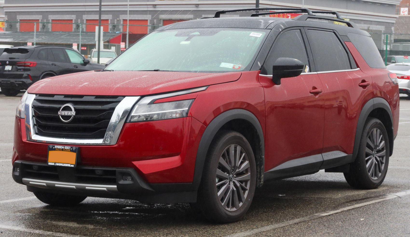 Front grille with bold chrome trim and LED headlights on red SUV