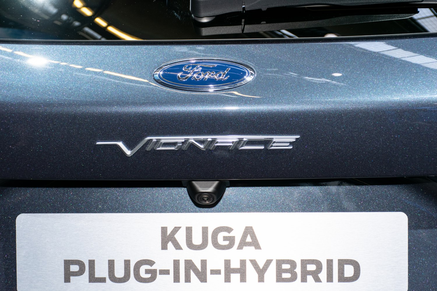 Close-up of Vignale badge and rear camera on metallic car surface