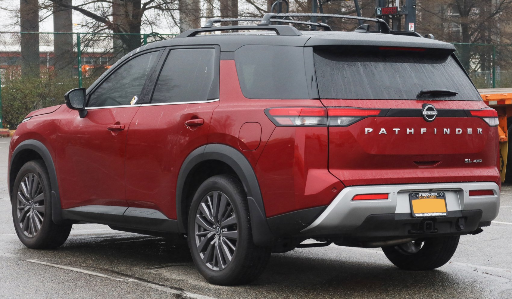 Red SUV rear with tail lights, 4WD badge and black roof design