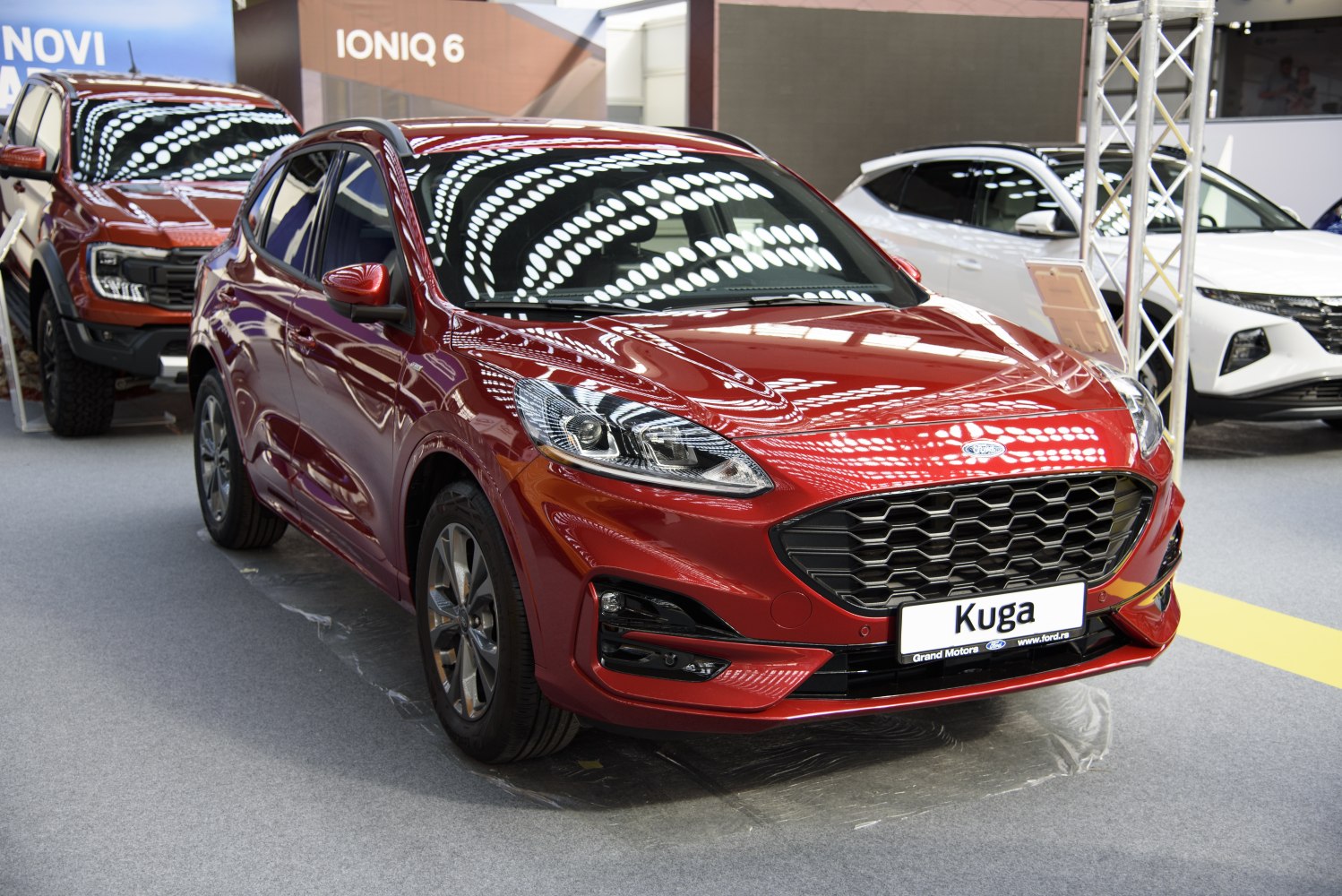 Front view with honeycomb grille and sharp headlights