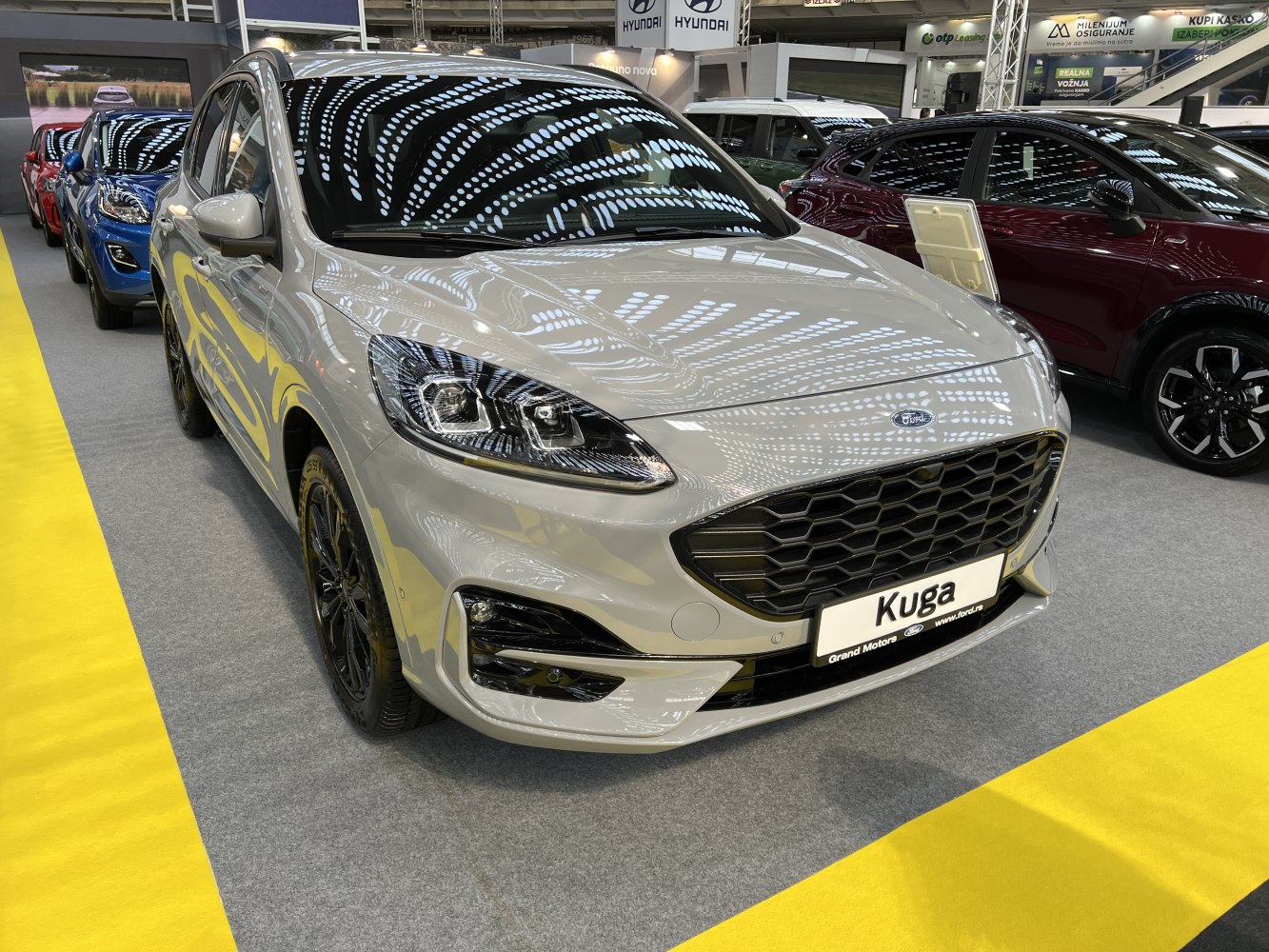 Close-up of SUV front grille and headlights in reflective light