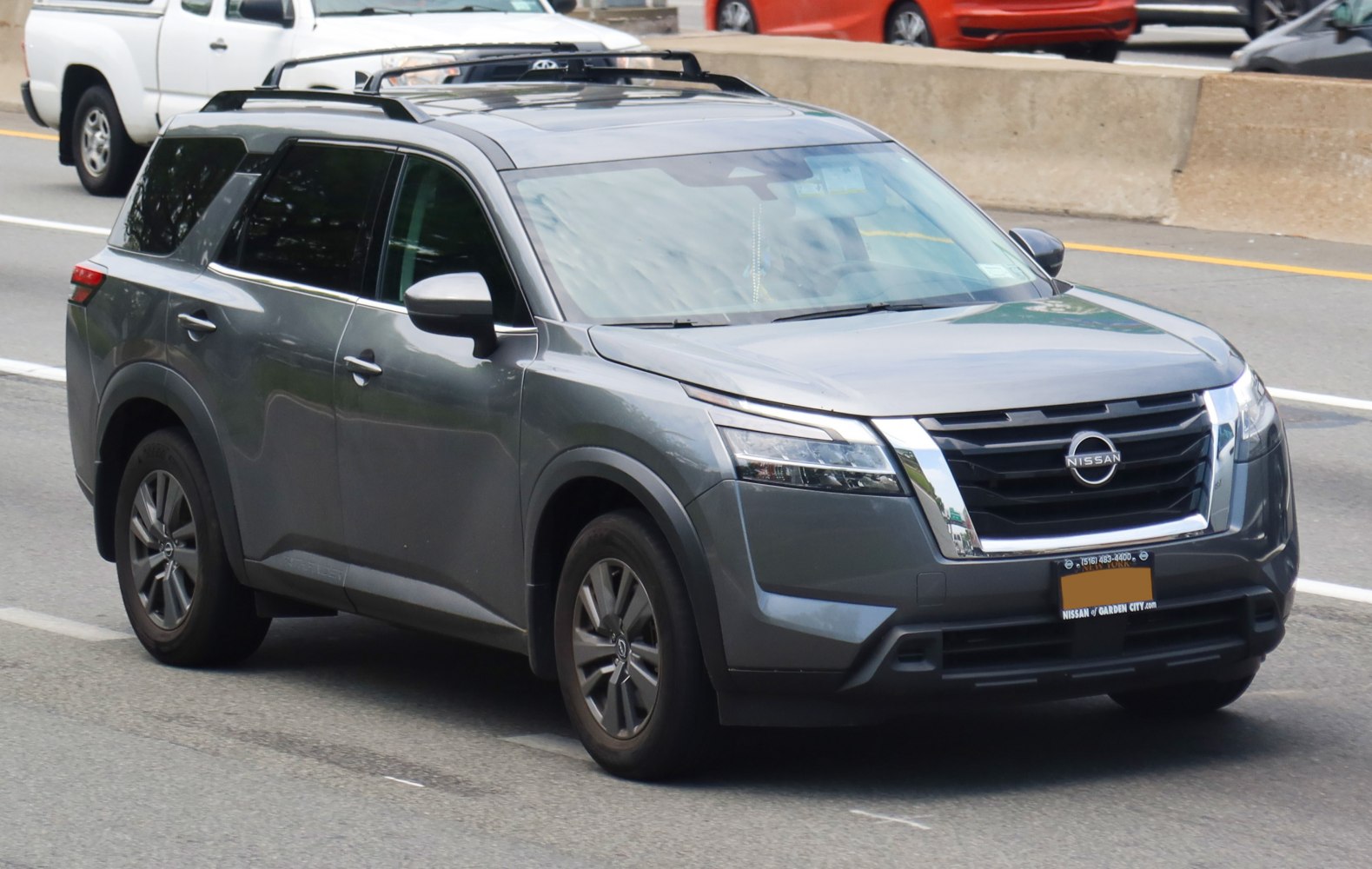 Gray SUV with modern grille and sleek headlights from front three-quarter view