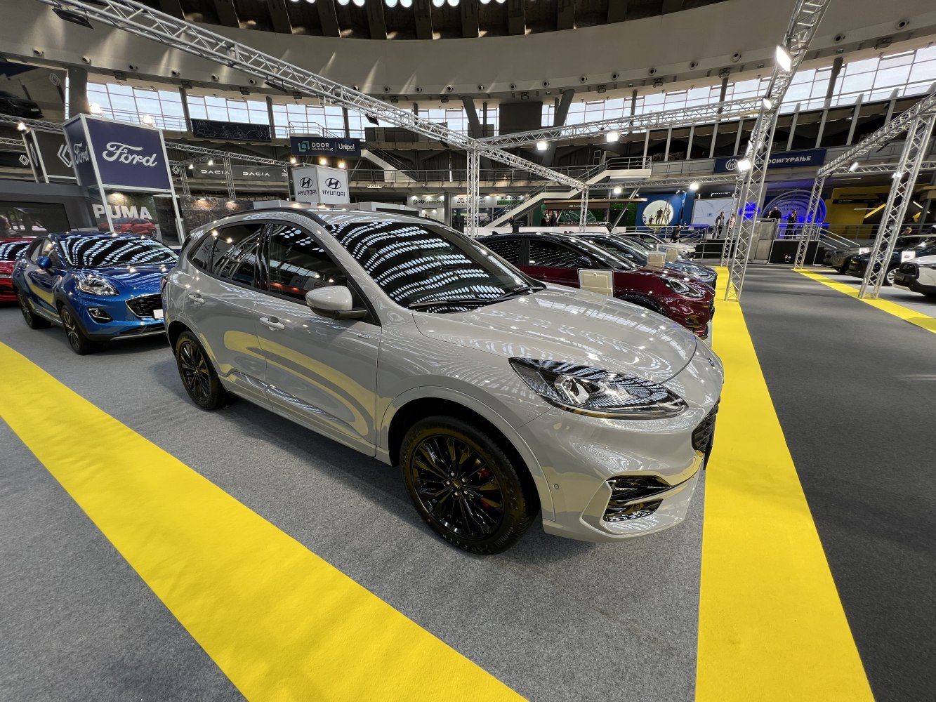 Silver SUV with black alloy wheels in an exhibition setting