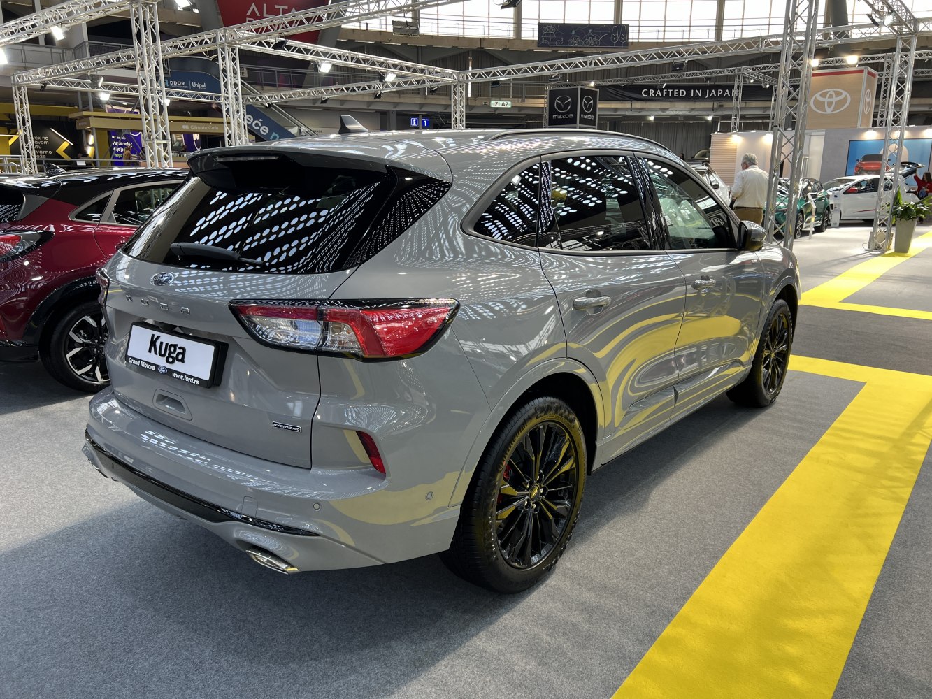 Rear and side view showcasing taillights and sporty alloy wheels.