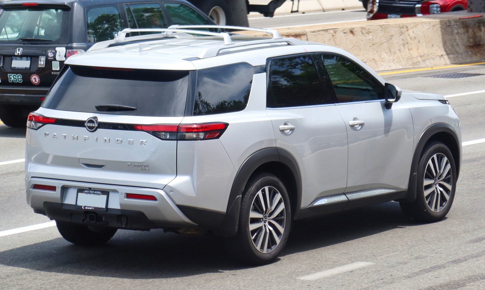 Rear view and side profile with roof rails and taillights