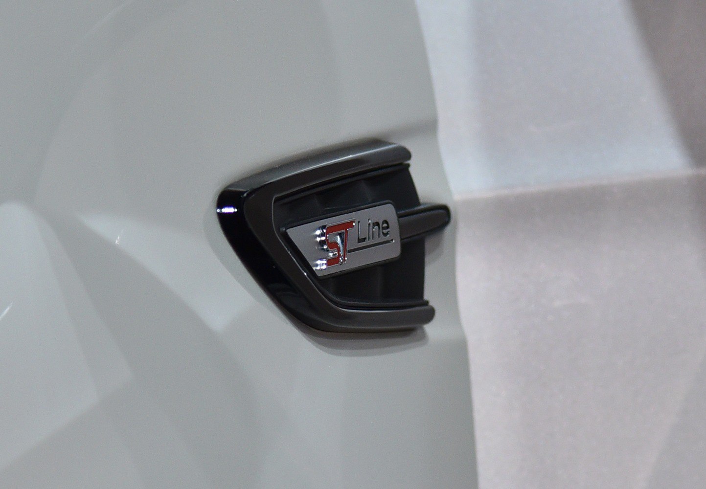 Close-up of black and chrome ST Line sport trim badge