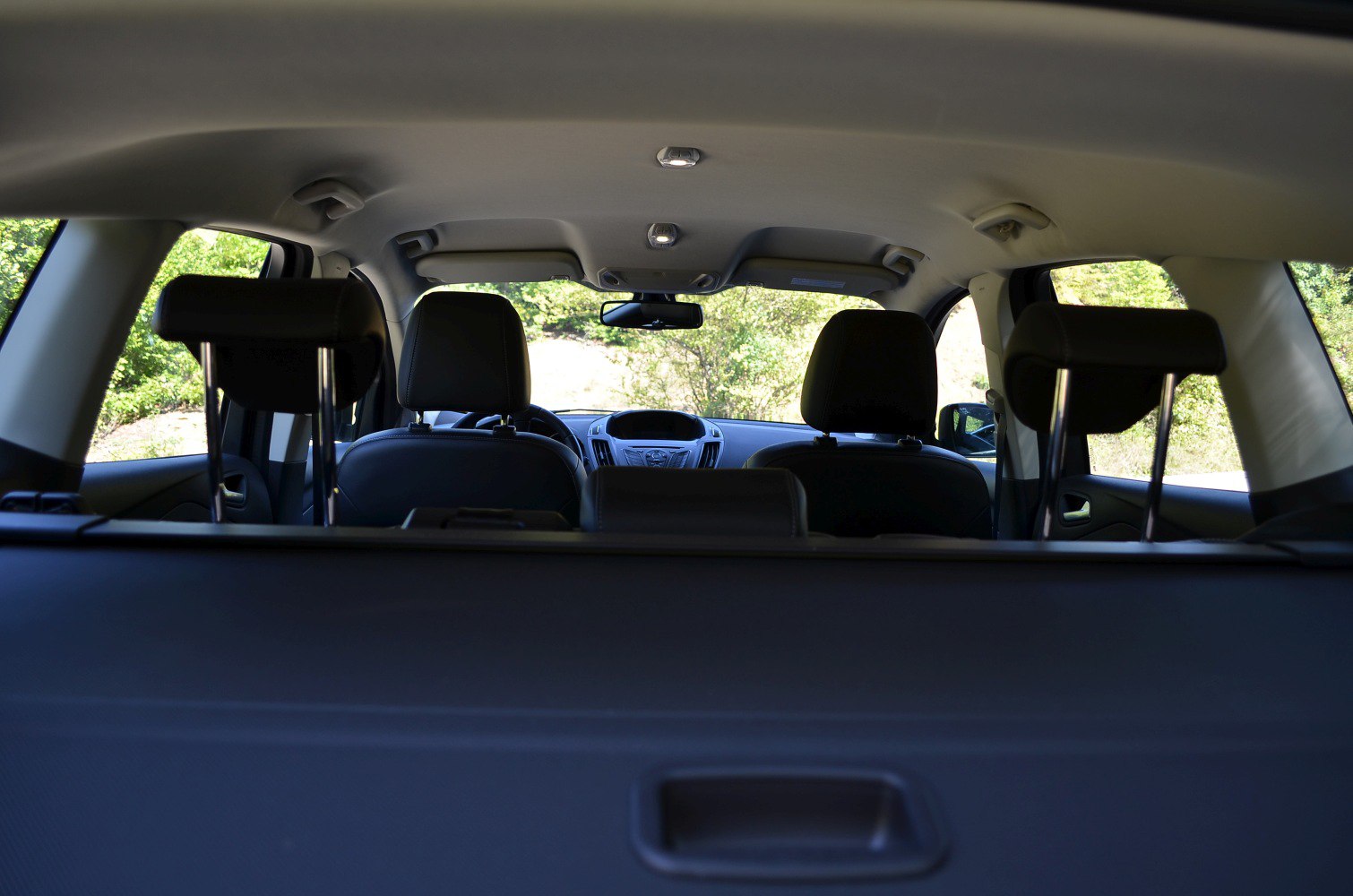 Rear seat headrests and dashboard interior with ceiling lights
