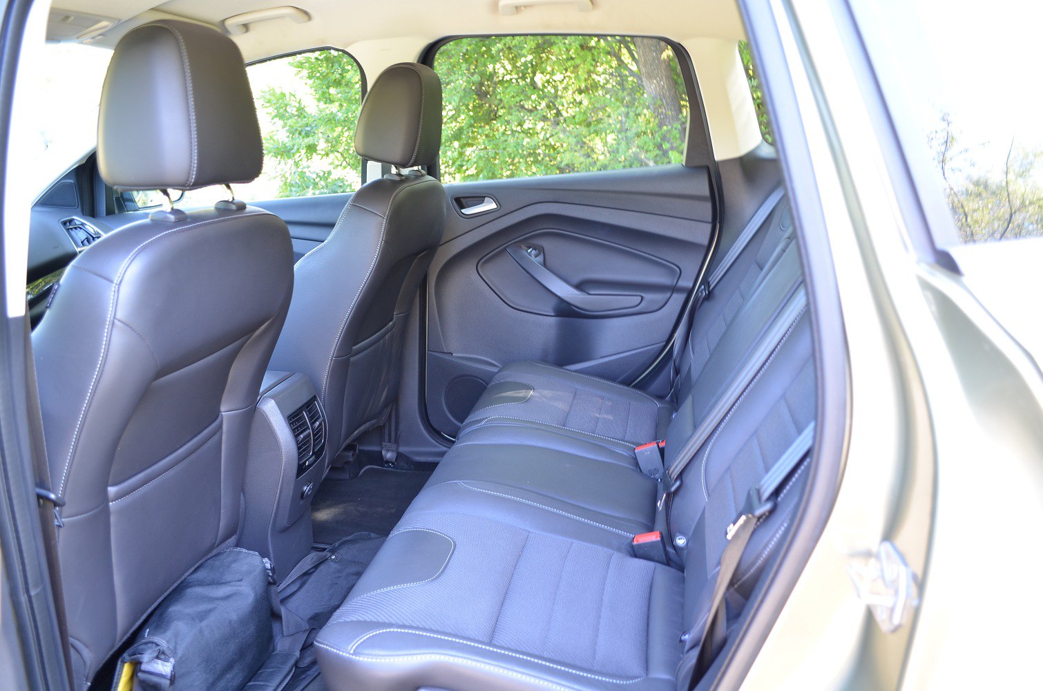 Spacious rear seat interior with leather upholstery and modern door panel details