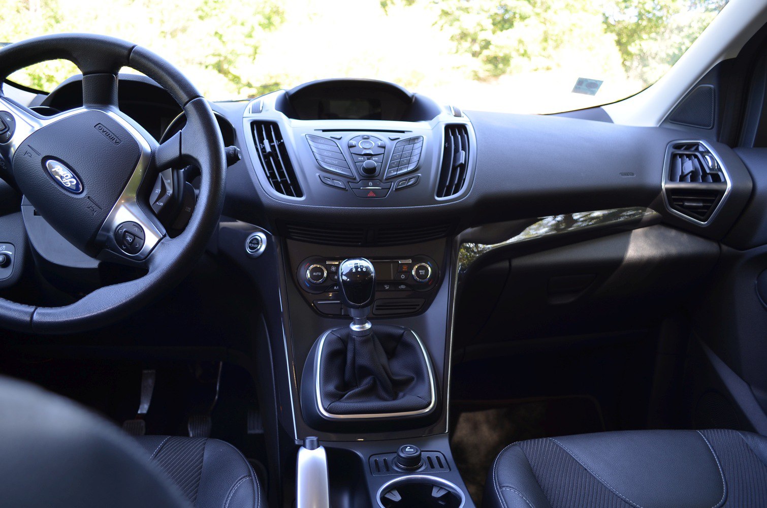 Manual gear shift, multifunction steering wheel, central console with dashboard controls