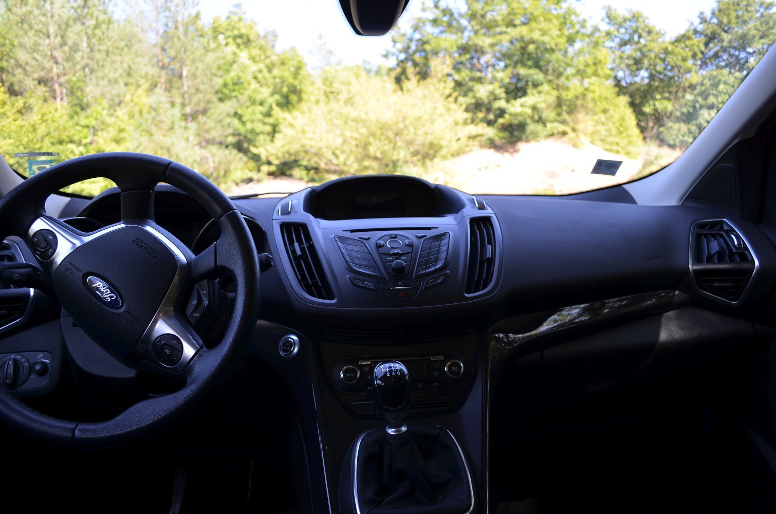 Car interior with manual gear shift and steering wheel controls