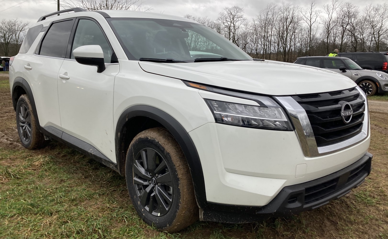 Front view of a white SUV with bold grille and LED headlights