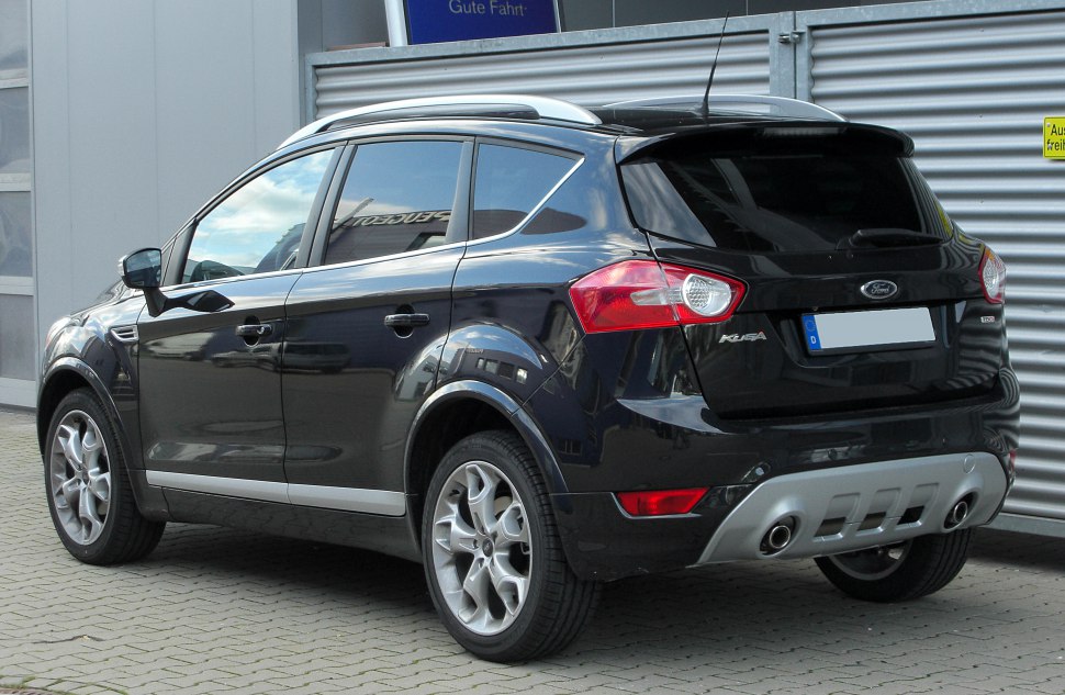 Rear side view of a black compact SUV with alloy wheels and roof rails