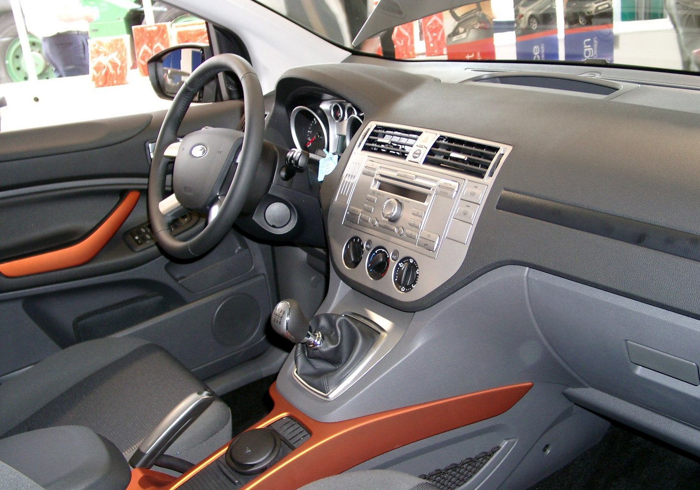 Manual gear shift and dashboard with controls in car interior