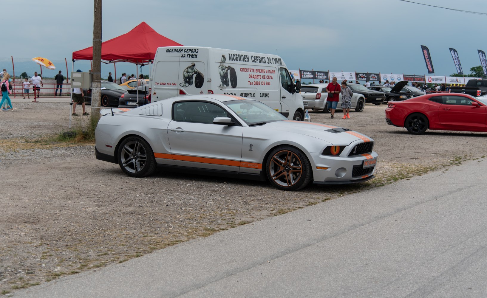 Silver Shelby II with orange racing stripes and side ventilation