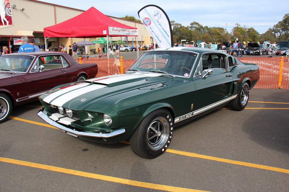 Vintage Mustang GT500 fastback with racing stripes and muscle car styling