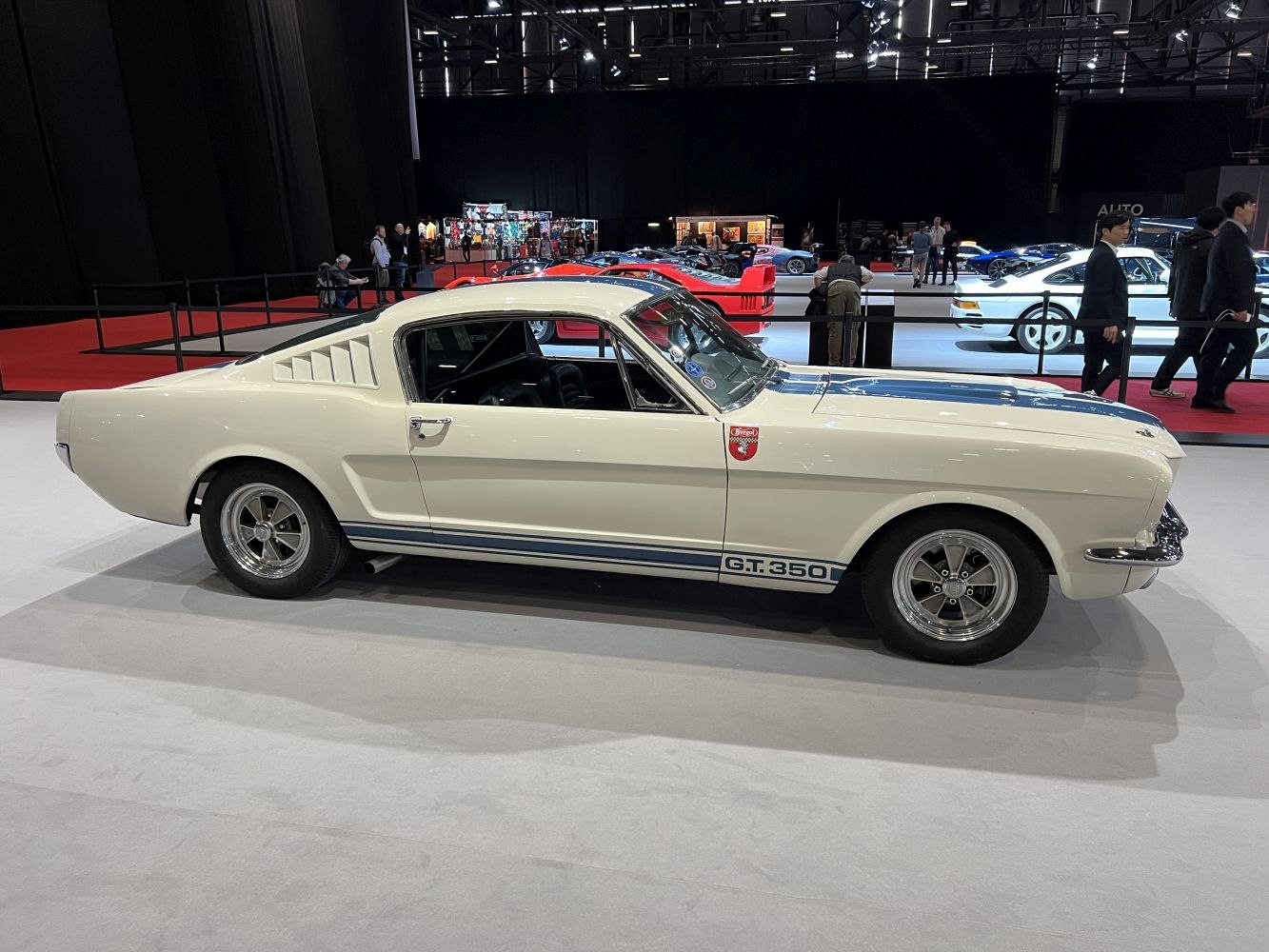 Side view of classic fastback with racing stripes and rear louvers