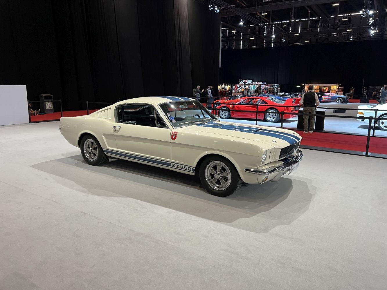 1965 fastback muscle car with racing stripes and chrome details