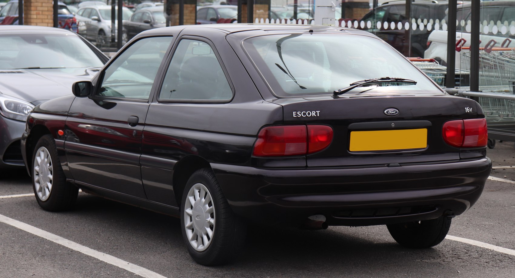 Rear view of a black compact hatchback with distinctive taillights