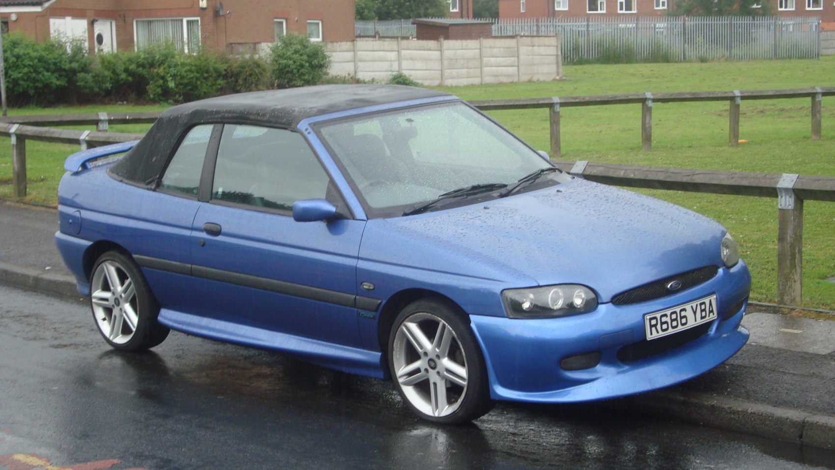 Blue convertible with black soft top and sporty alloy wheels