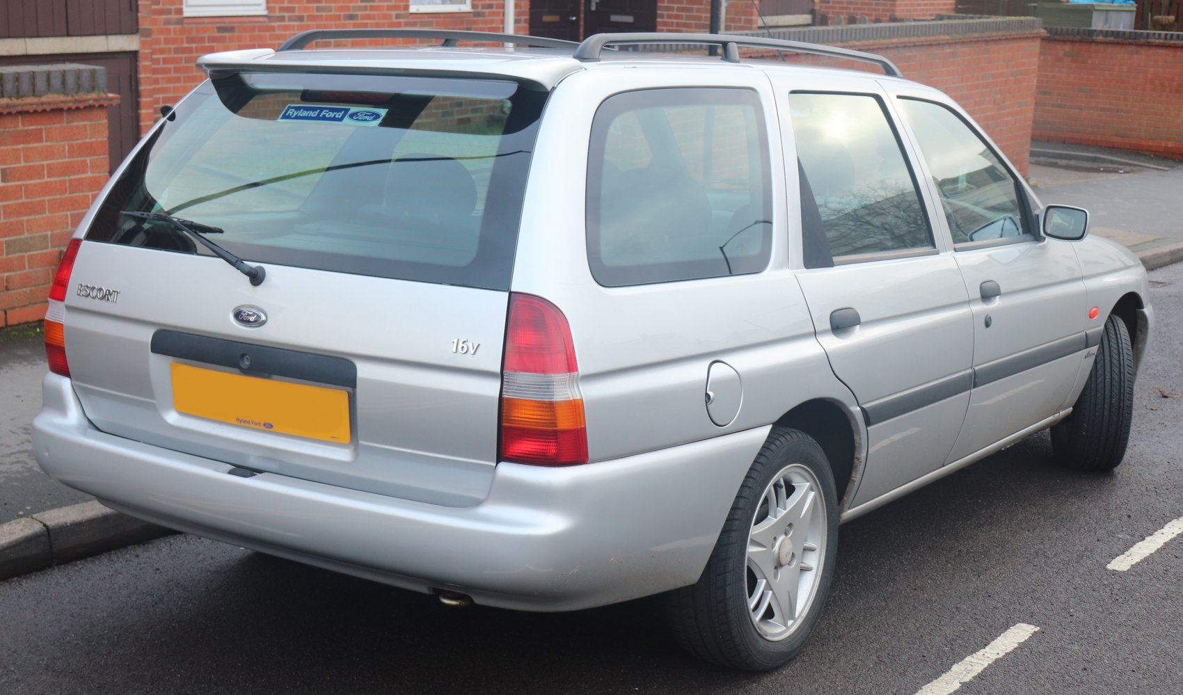 Silver compact wagon rear view with spoiler and roof rails