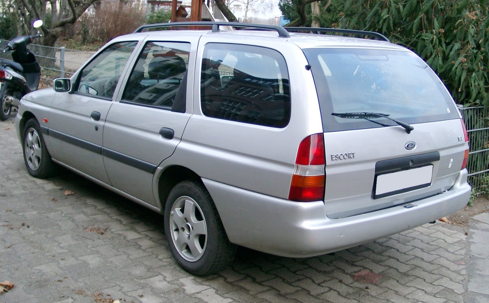 Silver station wagon rear and side view with roof rails and classic 1995-2000 design