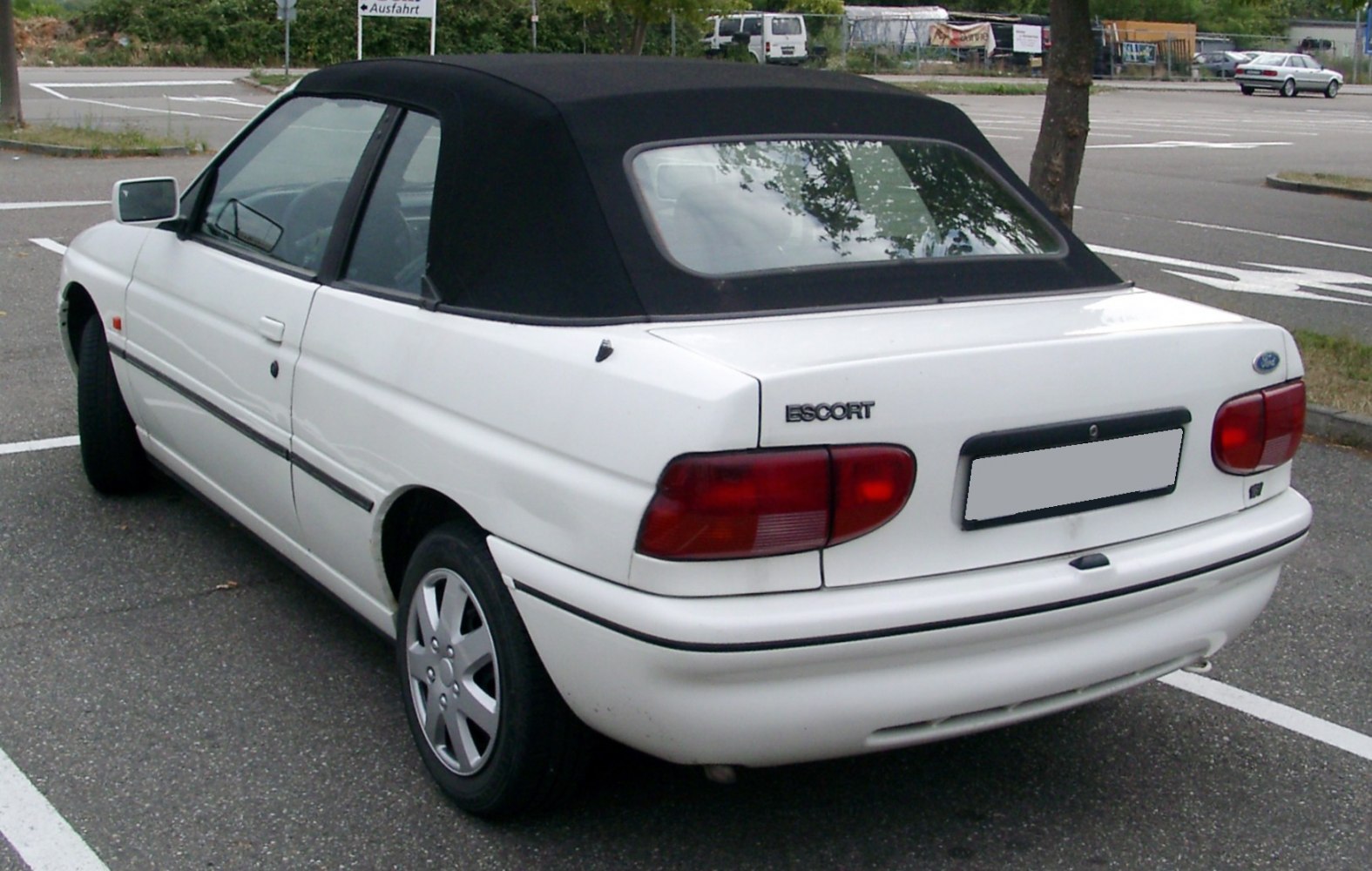 Rear view of white convertible with black soft top roof