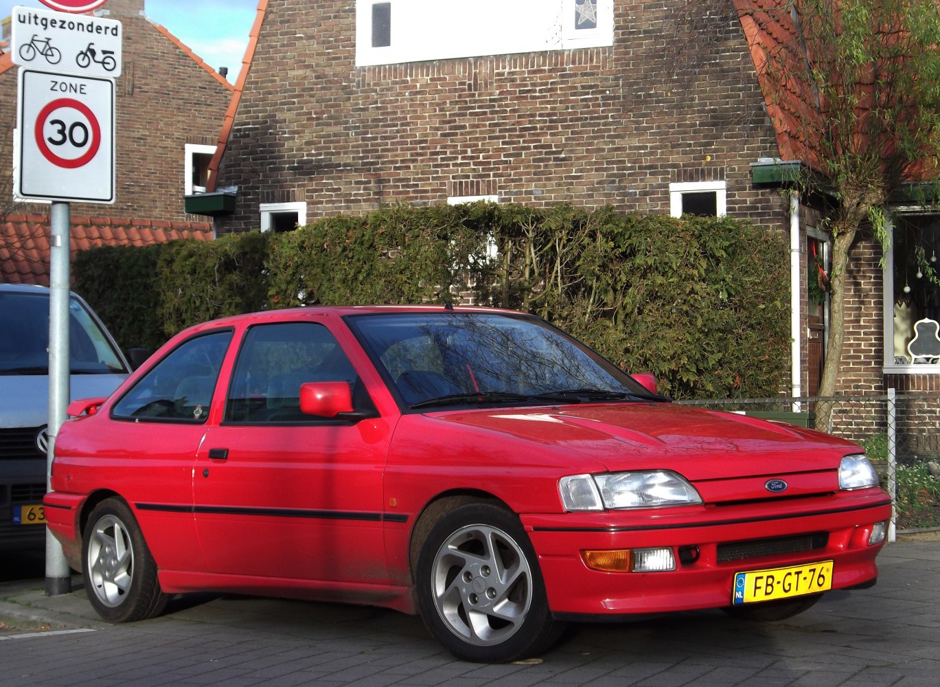 Red hatchback with alloy wheels front side view