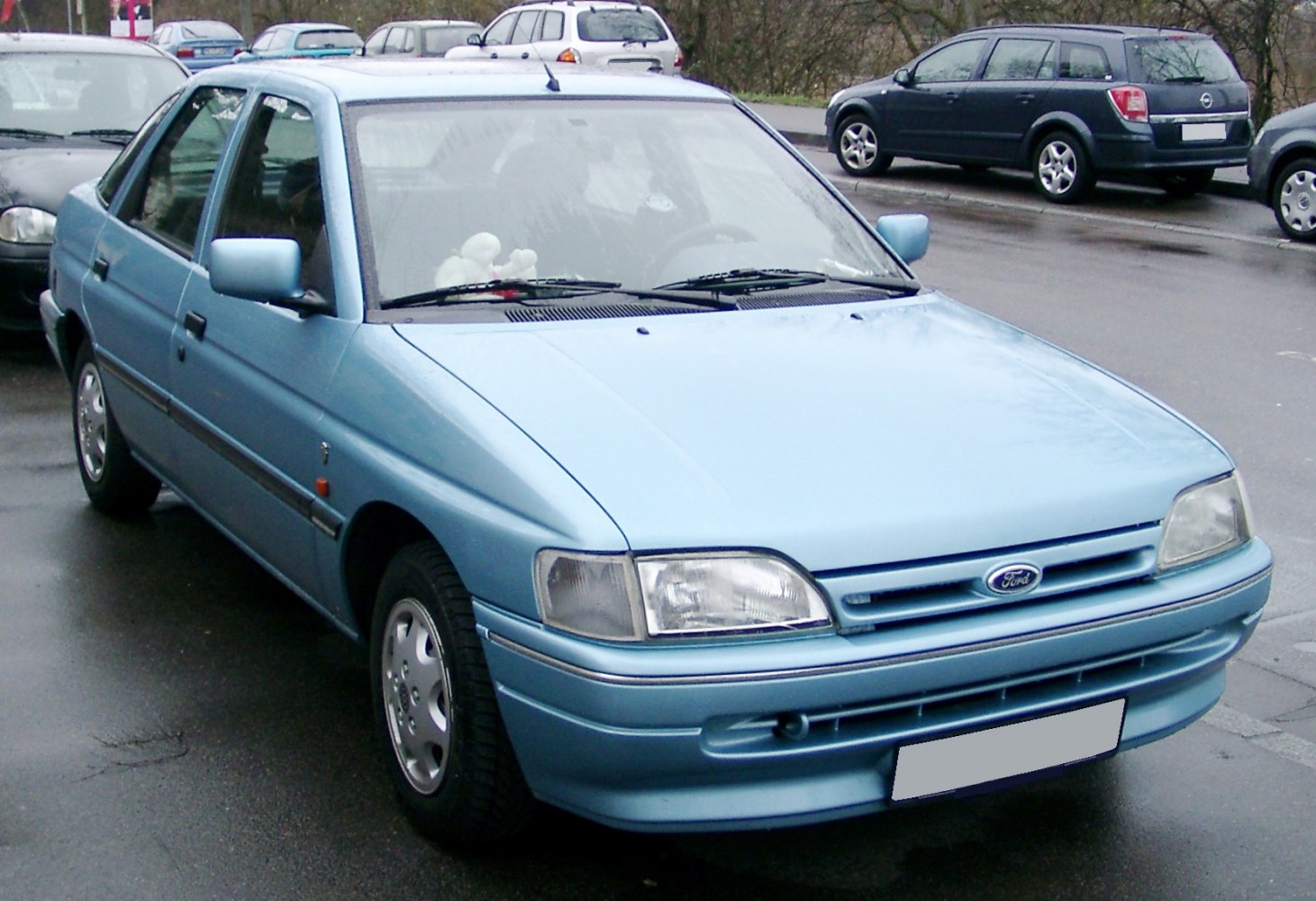 Light blue four-door sedan with rectangular headlights and a two-slat grille