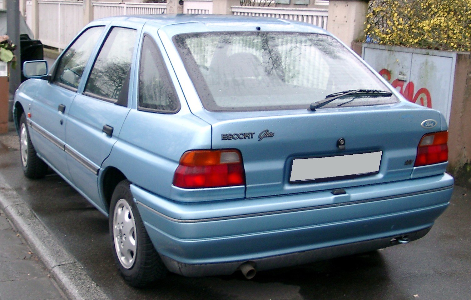 Rear view of compact hatchback with distinctive tail lights and rear wiper