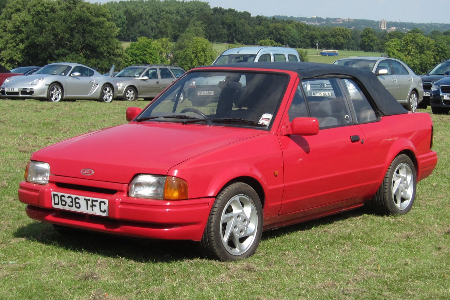 Red convertible with soft black top and alloy wheels