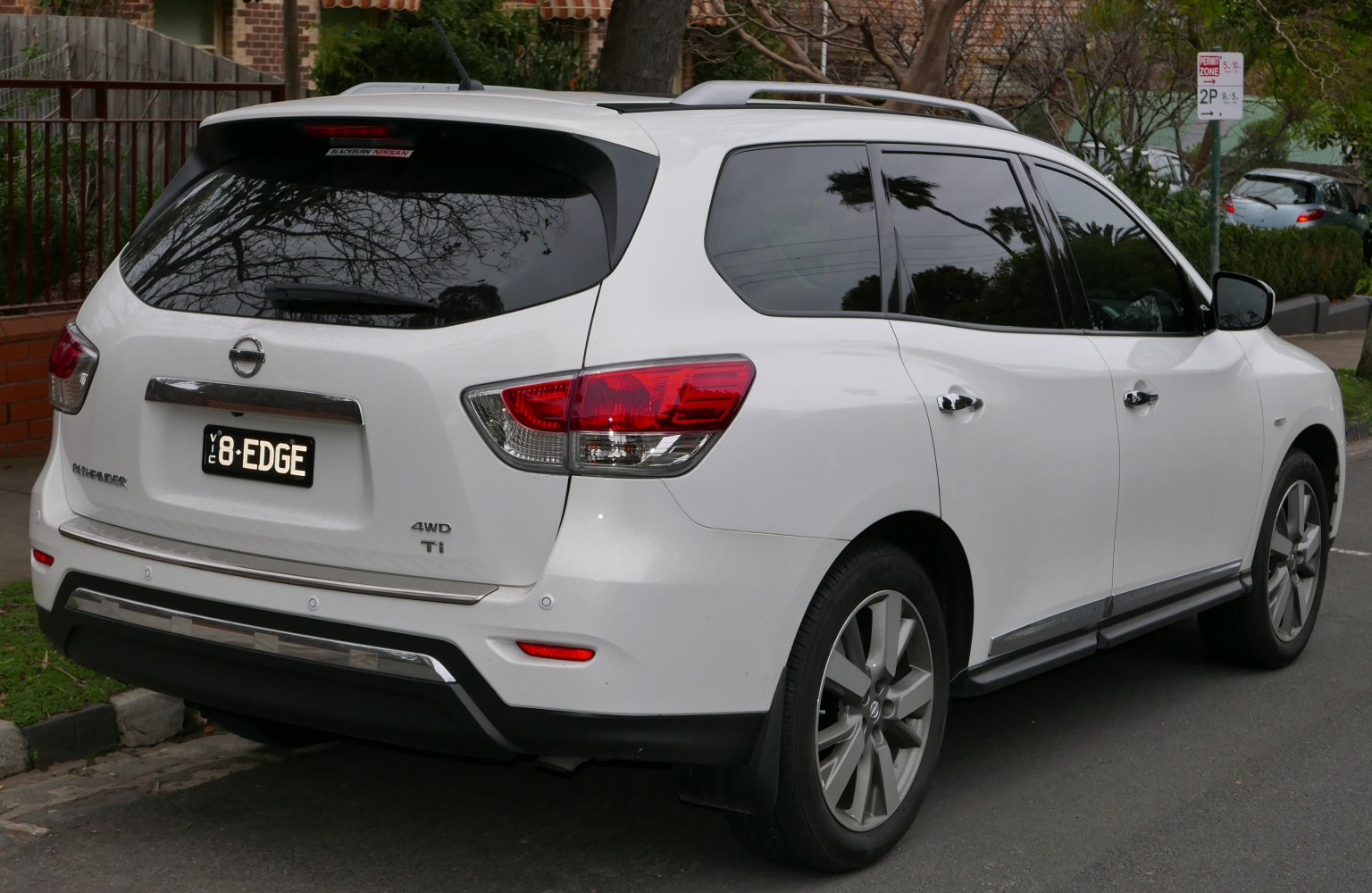 Rear and side view of a white 4WD SUV with tinted windows and alloy wheels