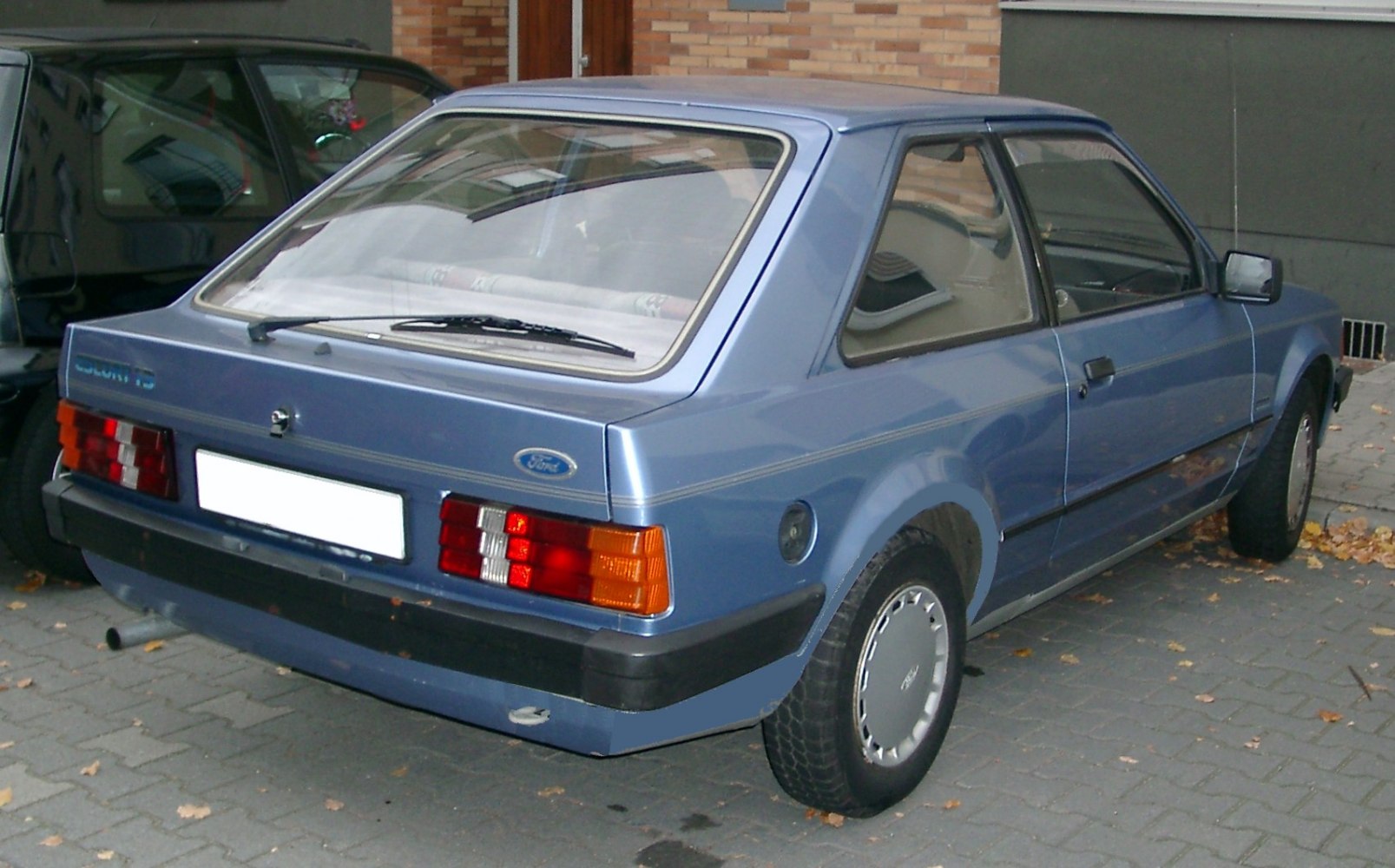 Compact hatchback with unique tail light cluster and rear window wiper