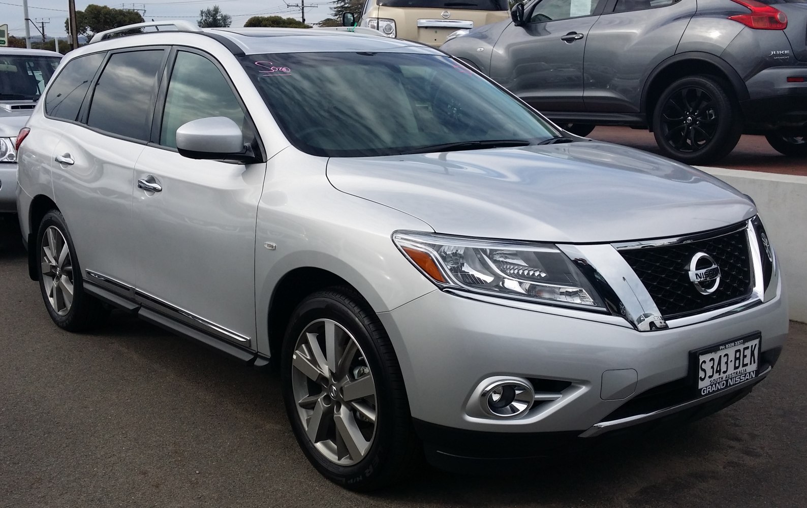 Silver SUV with chrome grille, angular headlights, and fog lights
