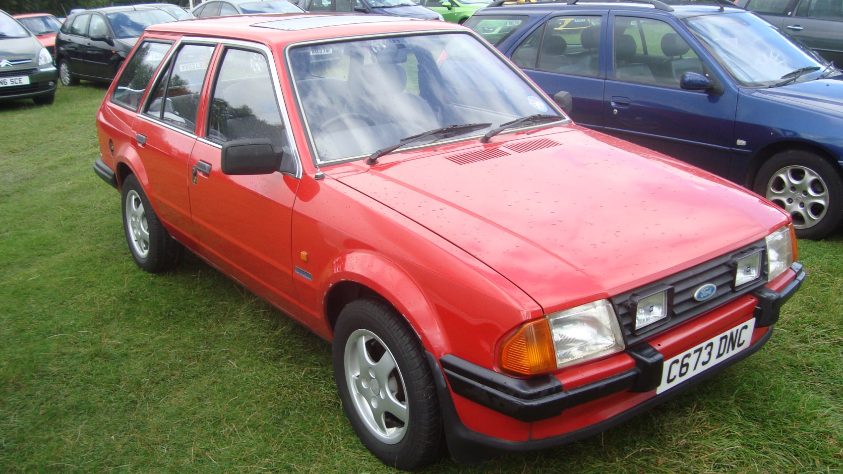 Boxy red station wagon with dual front fog lights