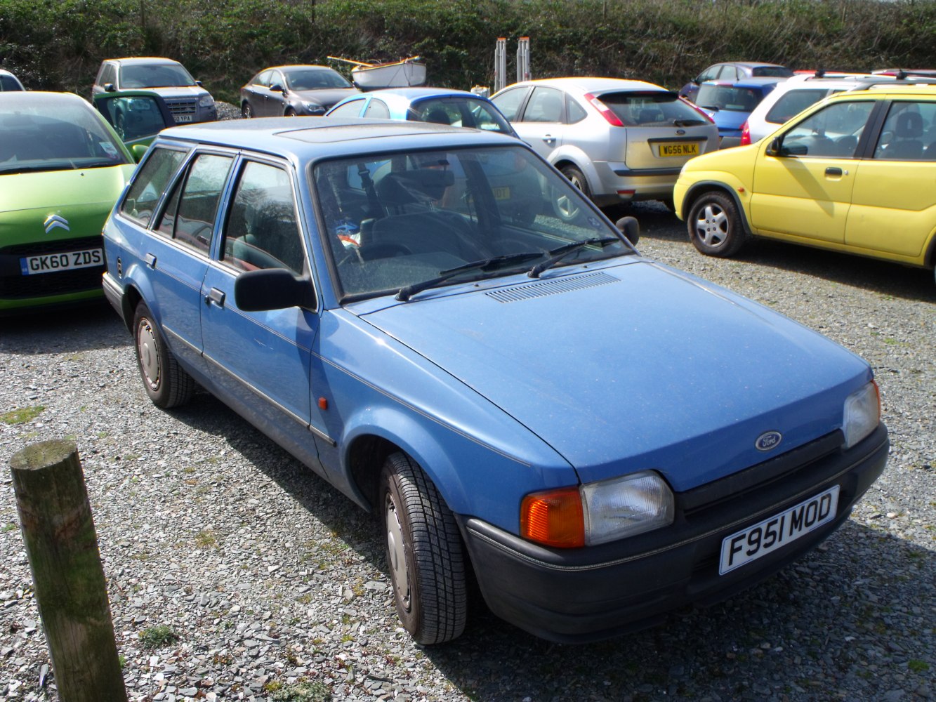 1980s blue station wagon with rectangular headlights and black bumper