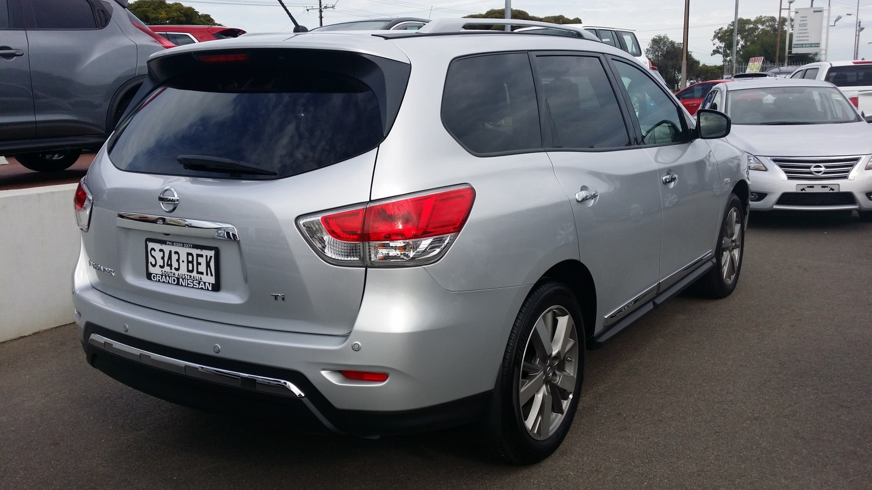Silver SUV rear view with taillights and roof rails