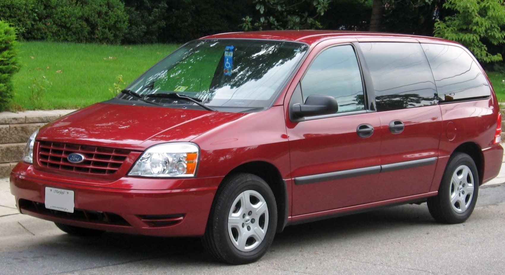 Red minivan with sliding doors and alloy wheels