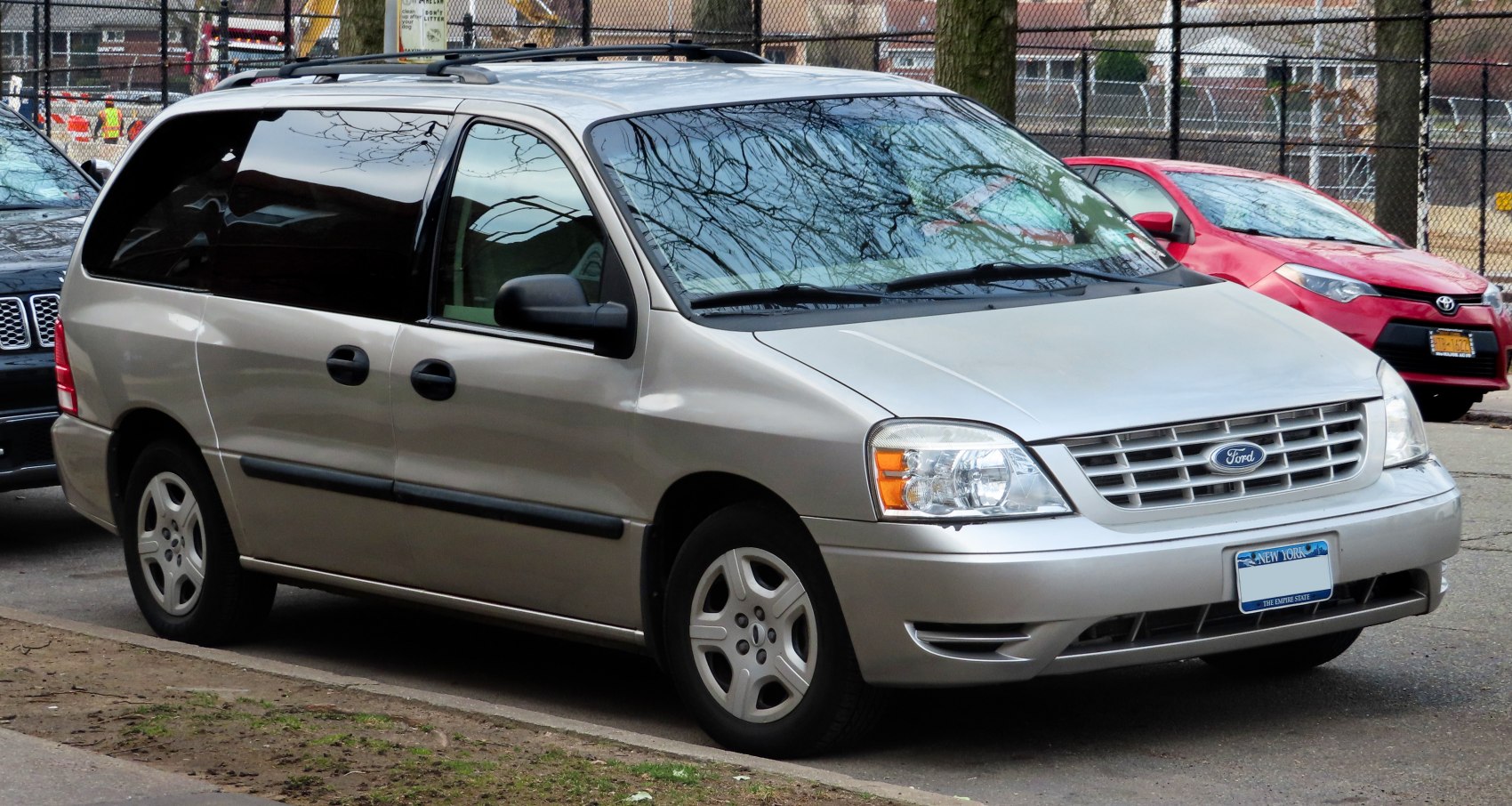 Minivan front side exterior with sliding rear door and alloy wheels