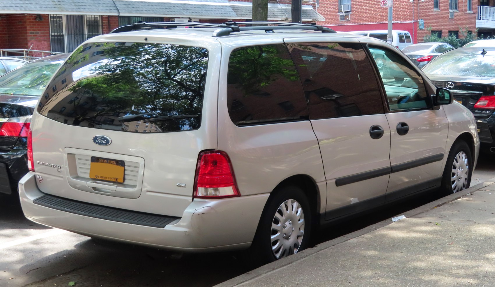Rear view of minivan with tinted windows and roof rack